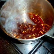 The making of the sauce: veal stock with ginger, orange liqueur, garlic and lemon zest