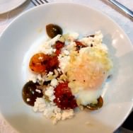 Soft egg, tomatoes in three colors served in three ways (fresh, roasted, and sun-dried, fennel and red onion salad, sheep fresh cheese and macadamia,