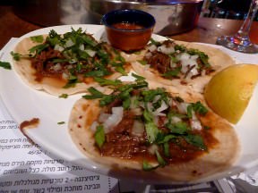 Carne Deshebrada: Slow cooked beef in a tomato and chili ancho sauce, onion and cilantro (28 NIS)