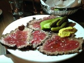 Whiskey Cured Beef Carpaccio, Dijon mustard, horseradish, cornichons (46 ILS). Chubby slices of meaty beef almost completely rare.