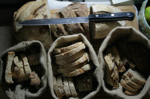 Three types of bread: White with raisins, whole wheat with walnuts, rye with olives.